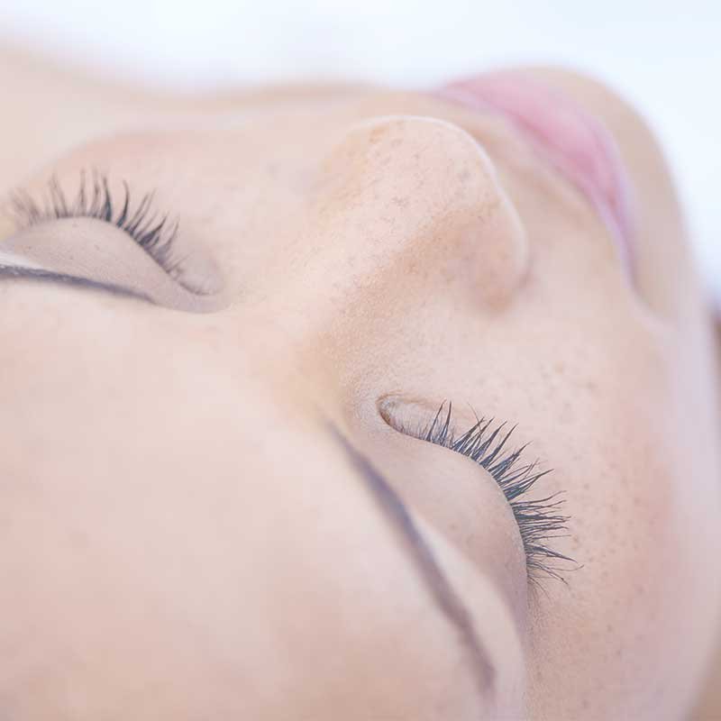 A women's face with beautiful eye brows and eye lashes.