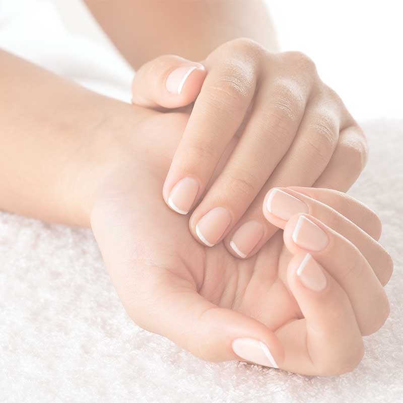 Womens hands showing lovely nails as a result of a nail biters makeover.